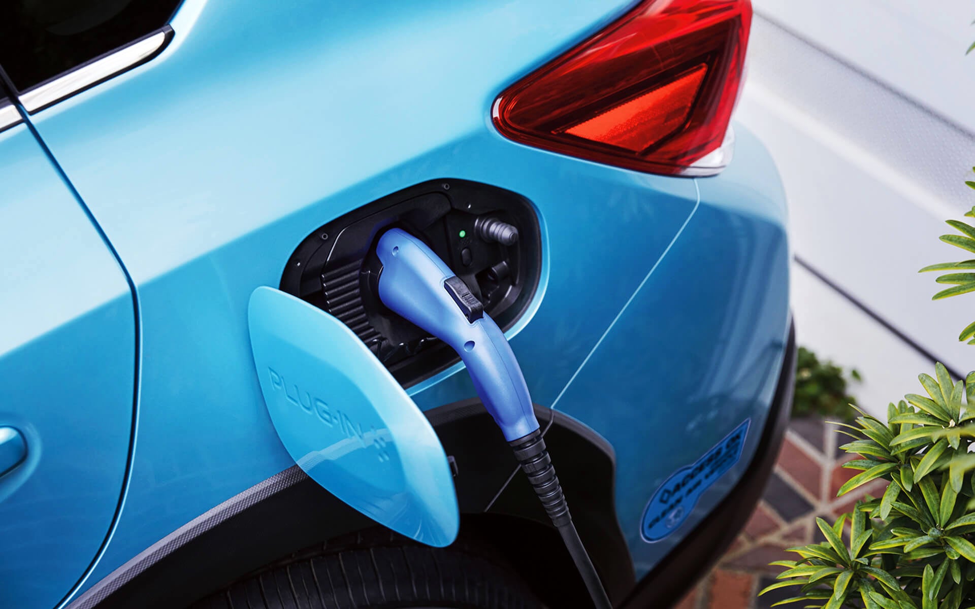A close-up of the Subaru Crosstrek Hybrid's charging port with charging cable plugged in | River City Subaru in Huntington WV