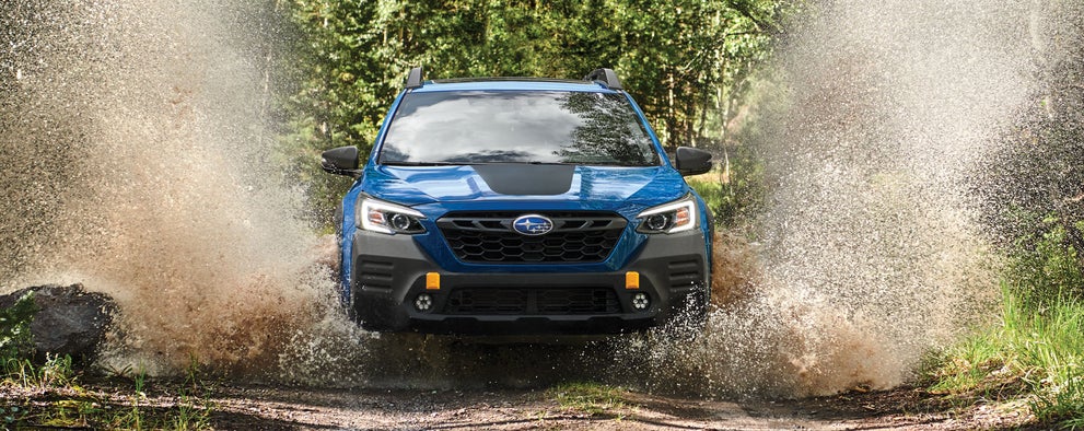 A 2023 Outback Wilderness driving on a muddy trail. | River City Subaru in Huntington WV