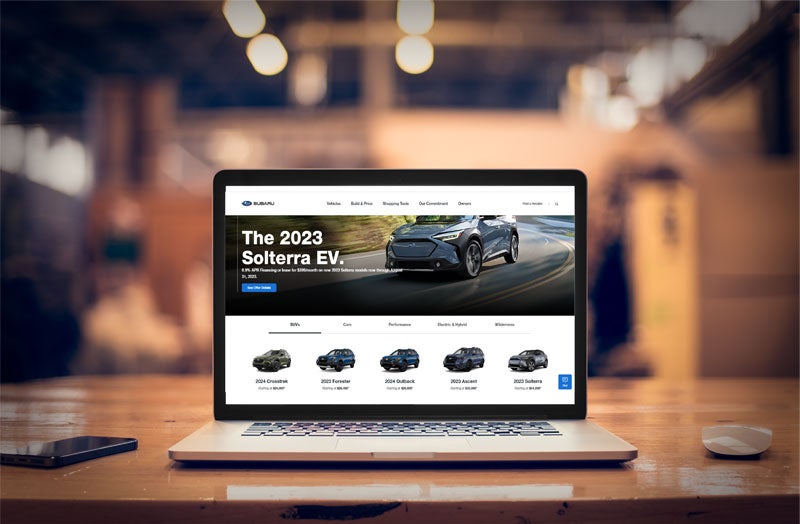 Laptop open with the Subaru model lineup.