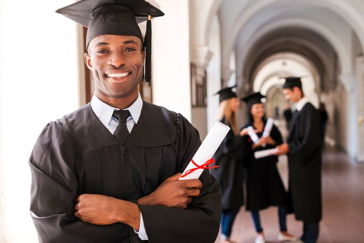 college graduate holding his diploma | River City Subaru in Huntington WV